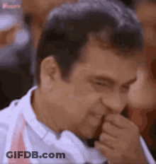 Man Covering Mouth While Looking GIF