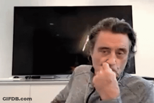 Man Covering Nose In Front Of Flat Screen TV GIF