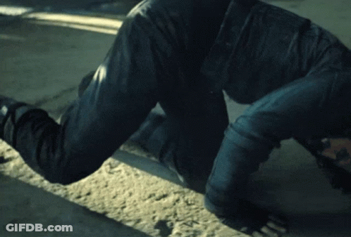 Man Crawling On Ground With Hands On Head GIF
