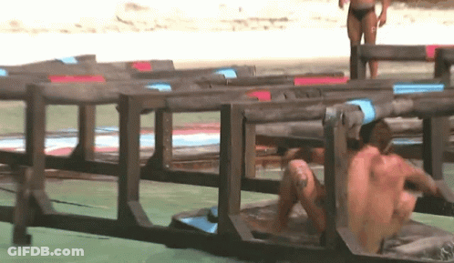 Man Crawling Through Wooden Fence Woman In Background GIF
