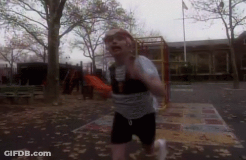 Man Crawling Under Yellow Ladder With Soccer Ball GIF