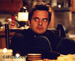 Man Cross-Legged In Chair Looking At Camera GIF