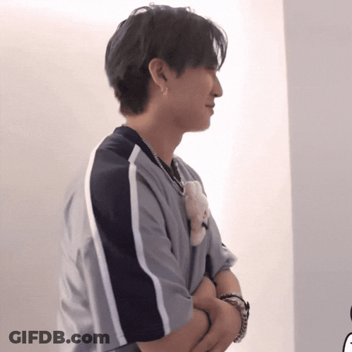 Man Crosses Arms Holding Teddy Bear GIF