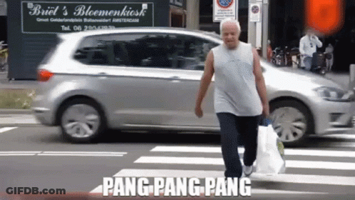 Man Crossing Street In Front Of Briel's Bloemenkiosk GIF