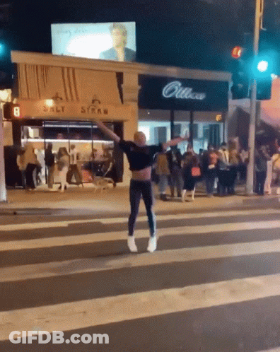Man Crossing Street In Front Of Salt Straw Store GIF