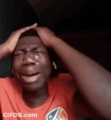 Man Crying And Holding Head While Wearing Headphones GIF