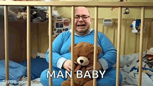 Man Crying Holding Teddy Bear In Crib Saying Man Baby GIF