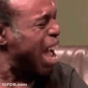 Man Crying On Couch Mouth Open Eyes Closed GIF