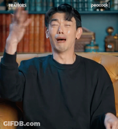 Man Crying On Couch With Hands In Air GIF