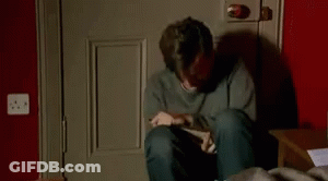 Man Crying On Floor Holding Box GIF