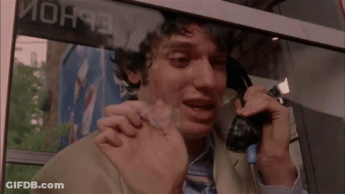 Man Crying On Phone In Front Of Mon93 Sign GIF