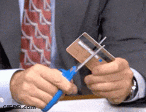 Man Cutting Credit Card With Scissors GIF