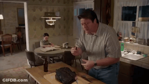 Man Cutting Meat On Board GIF