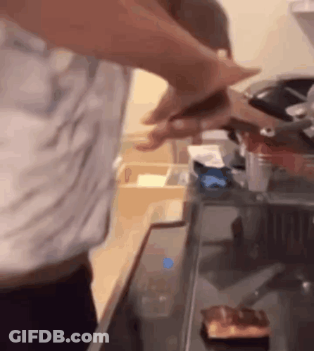 Man Cutting Meat On Stove Top GIF