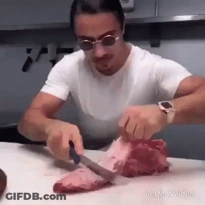 Man Cutting Meat With Knife GIF
