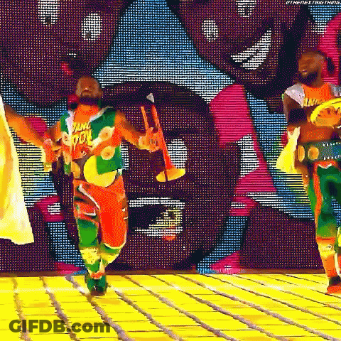 Man Dancing In Colorful Outfit Holding Trumpet GIF