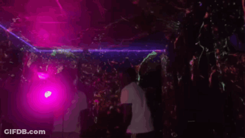Man Dancing In Dark Room With Purple Lights GIF