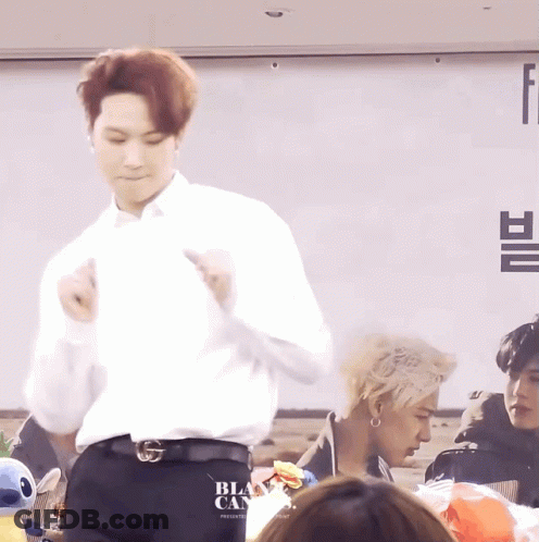 Man Dancing In Front Of Black Cans Sign GIF
