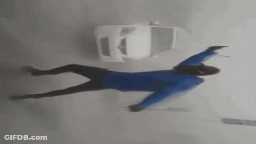 Man Dancing In Front Of Car In Foggy Street GIF