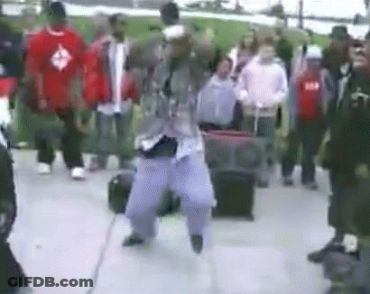 Man Dancing In Front Of Crowd On Street GIF