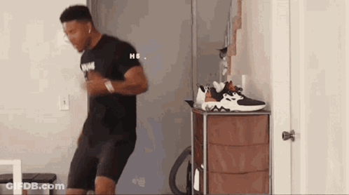 Man Dancing In Front Of Dresser With Shoes GIF