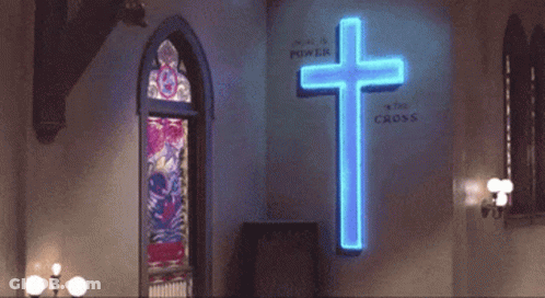 Man Dancing In Front Of Neon Cross Saying We Are A Power GIF
