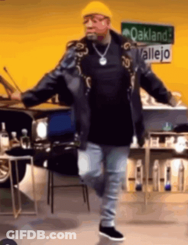 Man Dancing In Front Of Oakland Allejo Sign GIF
