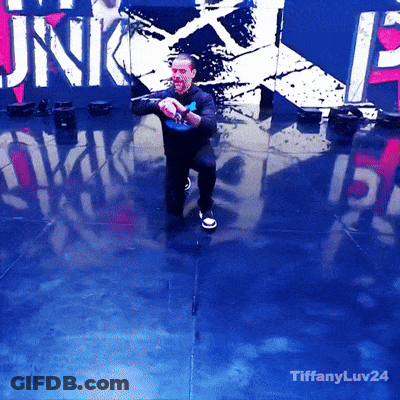 Man Dancing In Front Of Punk Sign GIF
