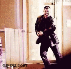 Man Dancing In Hallway In Front Of Door GIF