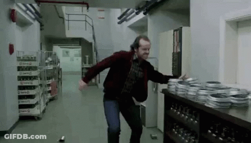 Man Dancing In Hallway In Front Of Film Reels GIF