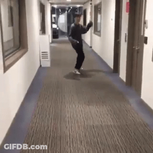 Man Dancing In Hallway With Skateboard GIF