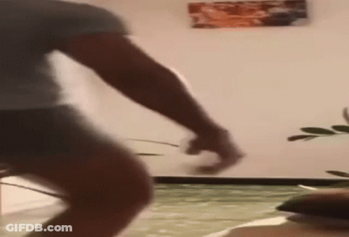 Man Dancing In Living Room In Front Of Picture GIF