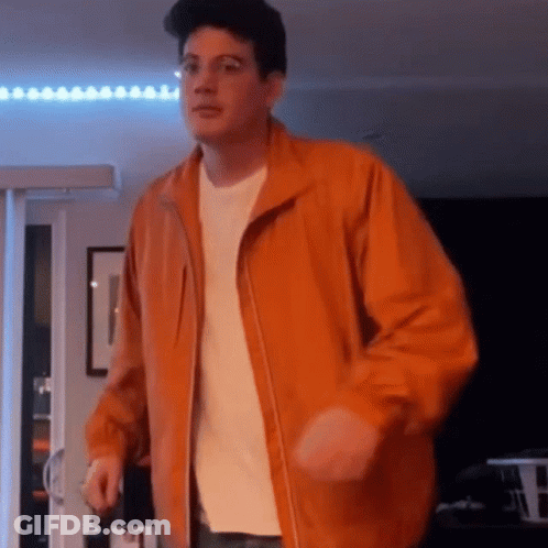 Man Dancing In Orange Jacket And White Shirt GIF