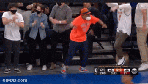 Man Dancing In Orange Shirt Before Crowd GIF