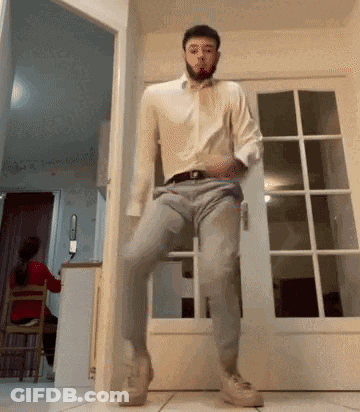 Man Dancing In White Shirt And Grey Pants GIF