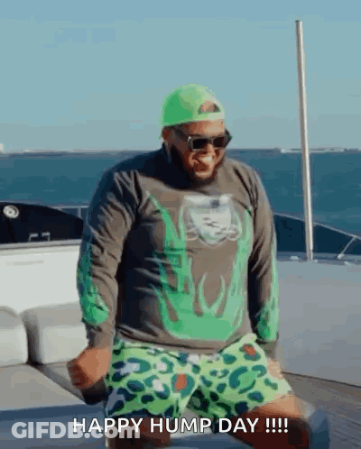 Man Dancing On Boat In Green Hat And Shorts GIF