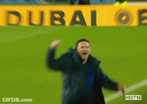 Man Dancing On Soccer Field In Front Of Dubai Sign GIF