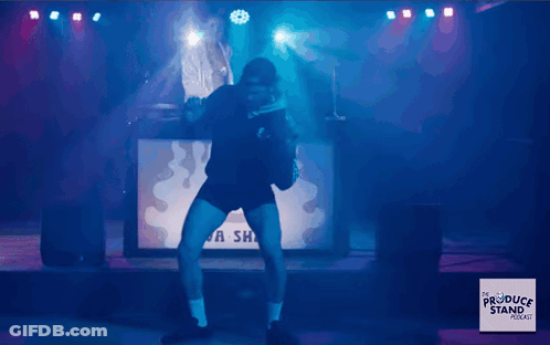 Man Dancing On Stage In Front Of A Sha Sign GIF