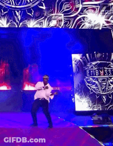Man Dancing On Stage In Front Of Embassy Screen GIF