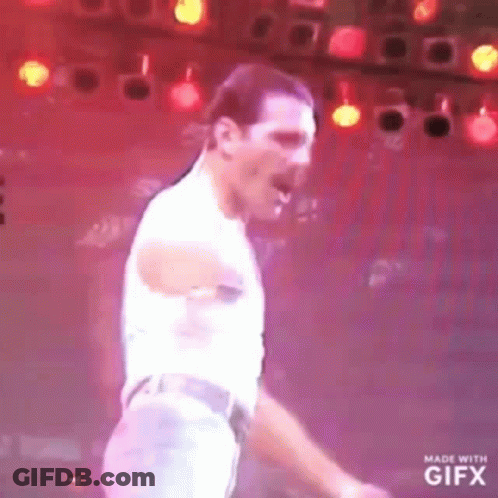 Man Dancing On Stage In Front Of Red Lights GIF