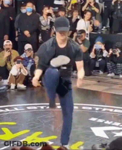 Man Dancing On Stage In Hat Before Crowd GIF