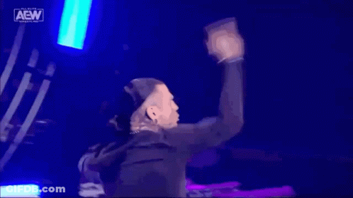 Man Dancing On Stage With AEW Sign GIF