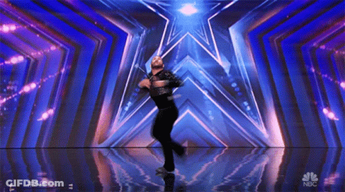 Man Dancing On Stage With NBC Logo GIF