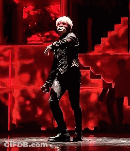 Man Dancing On Stage With Red Wall GIF