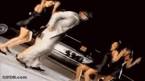 Man Dancing With Two Women In Front Of Car GIF