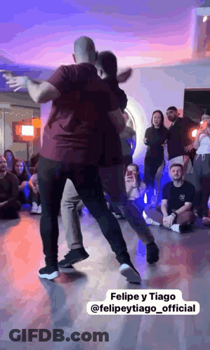 Man Dancing With Woman In Front Of Crowd GIF
