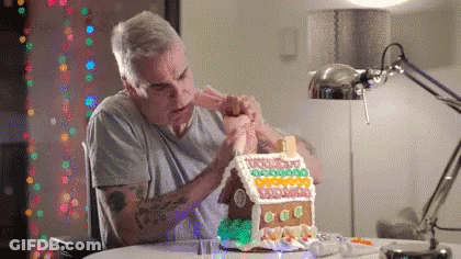 Man Decorating Gingerbread House GIF