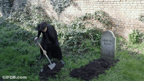 Man Digging At Heretic Keith Gravestone GIF