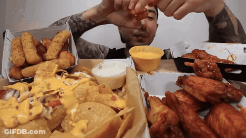 Man Dipping Chicken Wing In Yellow Sauce GIF