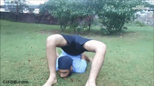 Man Doing Handstand In Grass Saying Awesome GIF